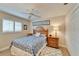 Inviting bedroom with a cozy bed, shuttered windows, ceiling fan, and tiled floors at 7566 Links Ct, Sarasota, FL 34243