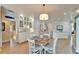 Bright dining area with a round table, stylish chairs, and a modern chandelier at 7566 Links Ct, Sarasota, FL 34243