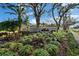 Community entrance sign, lush landscaping, and manicured lawn at 7566 Links Ct, Sarasota, FL 34243