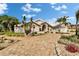 Attractive home featuring a brick driveway, mature palms, and lush landscaping for a welcoming curb appeal at 7566 Links Ct, Sarasota, FL 34243