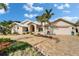 Charming home showcasing a brick driveway and manicured landscaping, enhancing its curb appeal at 7566 Links Ct, Sarasota, FL 34243