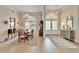 Formal dining area and foyer showcasing arched windows, tile flooring, and classic furniture at 7566 Links Ct, Sarasota, FL 34243