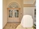 Elegant double front door with a fan window, situated on a brick path and decorative sconces at 7566 Links Ct, Sarasota, FL 34243