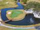 An island green with a bridge and a water feature on a pristine golf course at 7566 Links Ct, Sarasota, FL 34243