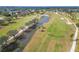 A golf course featuring a water hazard, mature trees, and meticulously manicured greens at 7566 Links Ct, Sarasota, FL 34243