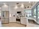 Well-equipped kitchen featuring stainless steel appliances, white cabinets, and ample counter space with a water view at 7566 Links Ct, Sarasota, FL 34243