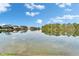 Calm lake view with trees and houses in the background on a sunny day at 7566 Links Ct, Sarasota, FL 34243