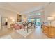 Bright living room with stylish furnishings, tile floors, and sliding glass doors to the pool area at 7566 Links Ct, Sarasota, FL 34243