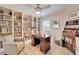 Inviting home office with built-in bookshelves, a ceiling fan, and classic decor at 7566 Links Ct, Sarasota, FL 34243