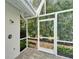 Outdoor shower in a screened lanai with a private garden view, offering a refreshing experience at 7566 Links Ct, Sarasota, FL 34243