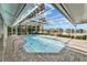 A gorgeous screened pool area overlooking a peaceful lake, with a retractable awning for adjustable shade at 7566 Links Ct, Sarasota, FL 34243