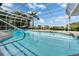 Sparkling pool with a tranquil view, complete with stairs and a handrail for easy access at 7566 Links Ct, Sarasota, FL 34243