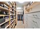 Spacious walk-in closet with ample storage and hanging space for clothing and shoe boxes at 7566 Links Ct, Sarasota, FL 34243