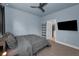 Relaxing bedroom featuring modern furnishings, ceiling fan and ensuite bathroom at 8716 N Brooks St, Tampa, FL 33604