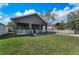 Inviting single-story home showcasing a well-manicured lawn and a classic porch at 8716 N Brooks St, Tampa, FL 33604