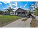 Inviting single-story home showcasing a well-manicured lawn, a classic porch and a private driveway at 8716 N Brooks St, Tampa, FL 33604