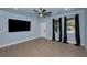 Bright and airy living room with modern flooring, neutral paint, and large windows with black curtains at 8716 N Brooks St, Tampa, FL 33604