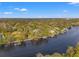 Scenic aerial view featuring waterfront homes with boat docks nestled along a river with lush surroundings at 906 W Henry Ave, Tampa, FL 33604