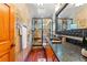 Bathroom featuring stone tile, granite countertops, a glass shower, and wood floors at 906 W Henry Ave, Tampa, FL 33604