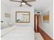 Bedroom featuring a large mirror, hardwood floors, and natural light at 906 W Henry Ave, Tampa, FL 33604