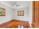 Bright bedroom featuring hardwood floors, a ceiling fan, and natural light at 906 W Henry Ave, Tampa, FL 33604