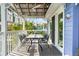 Covered deck with dining table, ceiling fan, and view of the tropical backyard at 906 W Henry Ave, Tampa, FL 33604