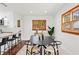 Bright dining room featuring a contemporary table set and wood-trimmed windows at 906 W Henry Ave, Tampa, FL 33604