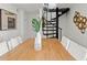 Bright dining room with a wood table, white chairs, and a unique black spiral staircase at 906 W Henry Ave, Tampa, FL 33604