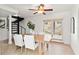 Inviting dining area with a cozy wood table, white chairs, and natural light from the sliding glass door at 906 W Henry Ave, Tampa, FL 33604