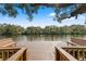 View of the wooden dock overlooking the tranquil river on a sunny day at 906 W Henry Ave, Tampa, FL 33604