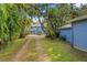 The exterior of the home is framed by tropical landscaping at 906 W Henry Ave, Tampa, FL 33604