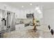 Bright kitchen features stainless steel appliances, white cabinets, pendant lighting, and a marble countertop at 906 W Henry Ave, Tampa, FL 33604