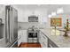 Charming kitchen with white cabinetry, stainless steel appliances, and a beautiful marble countertop at 906 W Henry Ave, Tampa, FL 33604