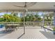 Spacious outdoor patio with lounge area overlooking the backyard and tropical scenery at 906 W Henry Ave, Tampa, FL 33604