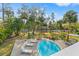 Aerial view of backyard pool with lounge chairs, lush landscaping, and water access at 906 W Henry Ave, Tampa, FL 33604