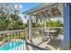 A view from the porch overlooking the pool and yard showing the outdoor furniture and decor at 906 W Henry Ave, Tampa, FL 33604