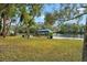 Riverfront with lawn, dock, boat lift, and lush tropical landscaping on a sunny day at 906 W Henry Ave, Tampa, FL 33604