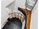 Spiral staircase with black metal railing and hardwood floors at 906 W Henry Ave, Tampa, FL 33604