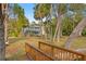 Lush yard with a dock, palm trees, and a charming two-story house in the background at 906 W Henry Ave, Tampa, FL 33604