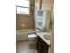 Bathroom with tub, toilet and brown vanity at 929 Windton Oak Dr, Ruskin, FL 33570