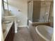 Primary bathroom with double vanity and garden tub at 929 Windton Oak Dr, Ruskin, FL 33570