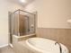 Bathroom features a shower and a soaking tub at 929 Windton Oak Dr, Ruskin, FL 33570