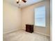 Bright bedroom featuring a window with blinds and wood nightstand at 929 Windton Oak Dr, Ruskin, FL 33570