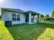 House exterior showcasing back patio and grassy lawn at 929 Windton Oak Dr, Ruskin, FL 33570