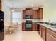 Spacious kitchen featuring dark wood cabinets and black appliances at 929 Windton Oak Dr, Ruskin, FL 33570