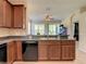 Kitchen with an island, dark wood cabinets, and a breakfast bar at 929 Windton Oak Dr, Ruskin, FL 33570