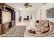 Living room with curved sofa, wooden shelving, and area rug at 929 Windton Oak Dr, Ruskin, FL 33570