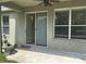 Covered patio with sliding glass doors and ceiling fan at 929 Windton Oak Dr, Ruskin, FL 33570