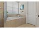 Bathroom with large soaking tub and window at 9426 59 N St, Pinellas Park, FL 33782