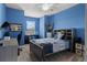 Blue bedroom with a full-size bed, built-in shelving, and a workspace at 9426 59 N St, Pinellas Park, FL 33782